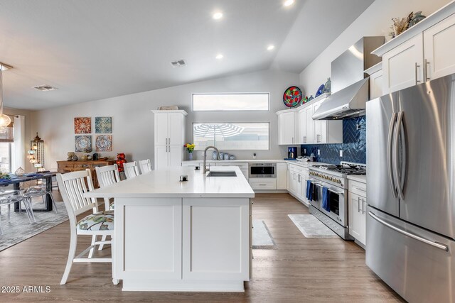 8738 W Runion Dr, Peoria, AZ 85382 - kitchen featuring appliances with stainless steel finishes, a sink, light countertops, tasteful backsplash, and a kitchen island with sink