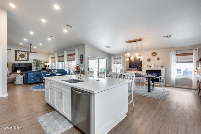 8738 W Runion Dr, Peoria, AZ 85382 - kitchen with dishwasher, open floor plan, a sink, white cabinetry, and an island with sink