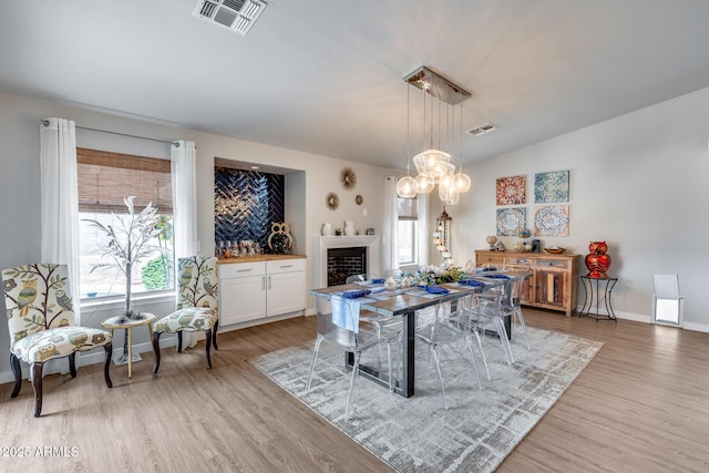 8738 W Runion Dr, Peoria, AZ 85382 - dining space with light wood-style floors, plenty of natural light, and baseboards
