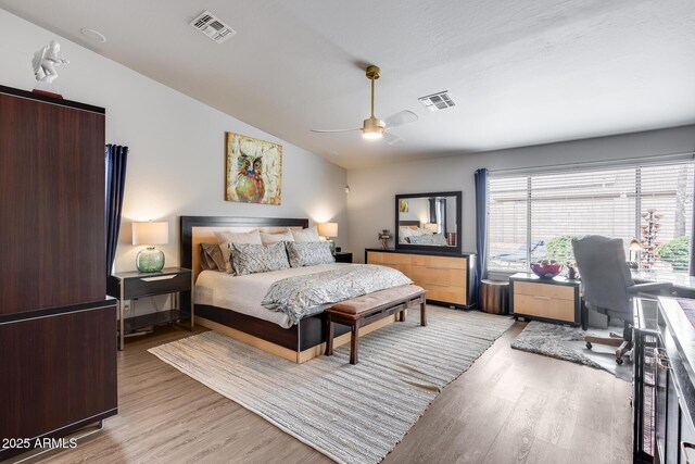 8738 W Runion Dr, Peoria, AZ 85382 - bedroom with vaulted ceiling, light wood-style floors, multiple windows, and a ceiling fan