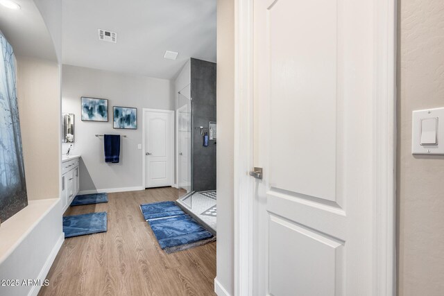 8738 W Runion Dr, Peoria, AZ 85382 - bathroom featuring wood finished floors, vanity, a stall shower, and baseboards