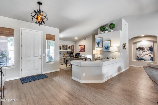8738 W Runion Dr, Peoria, AZ 85382 - entryway with light wood finished floors, vaulted ceiling, baseboards, and arched walkways