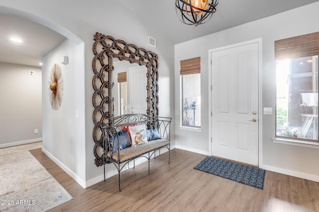 8738 W Runion Dr, Peoria, AZ 85382 - foyer entrance with arched walkways, wood finished floors, and baseboards