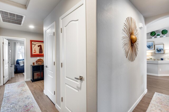 8738 W Runion Dr, Peoria, AZ 85382 - corridor with light wood finished floors, baseboards, arched walkways, and recessed lighting