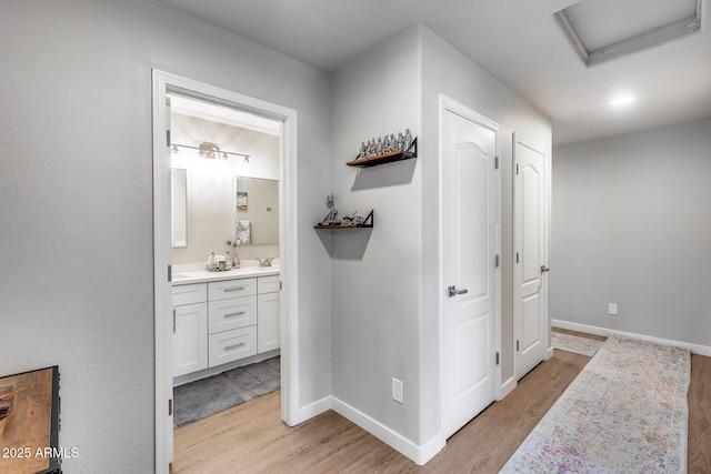 8738 W Runion Dr, Peoria, AZ 85382 - hall with light wood finished floors, baseboards, and attic access