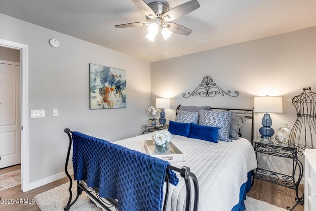 8738 W Runion Dr, Peoria, AZ 85382 - bedroom featuring wood finished floors, baseboards, and a ceiling fan