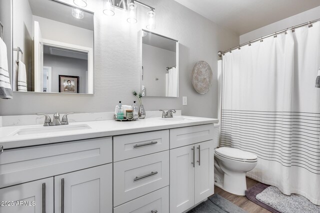 8738 W Runion Dr, Peoria, AZ 85382 - bathroom featuring double vanity, toilet, wood finished floors, and a shower with curtain