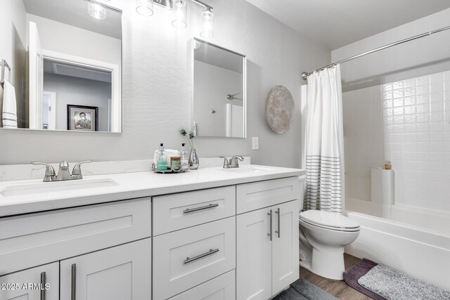 8738 W Runion Dr, Peoria, AZ 85382 - full bath with double vanity, shower / bath combo, toilet, and wood finished floors