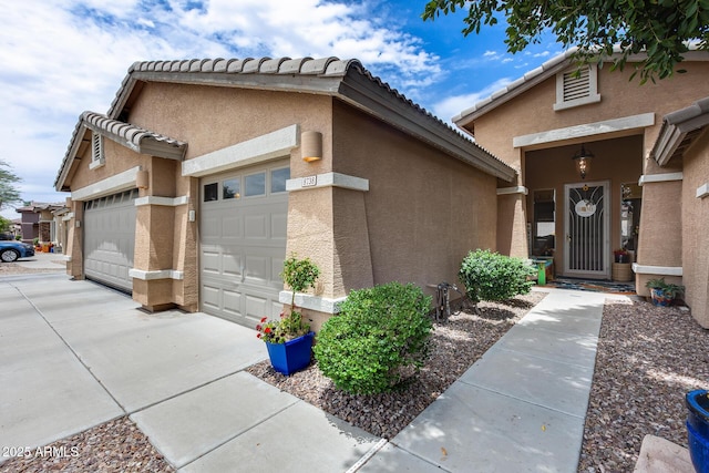 8738 W Runion Dr, Peoria, AZ 85382 - view of front facade featuring an attached garage, stucco siding, driveway, and a tile roof