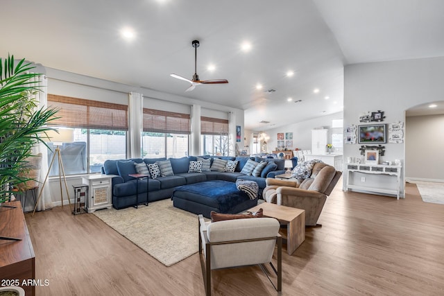 8738 W Runion Dr, Peoria, AZ 85382 - living area with a ceiling fan, arched walkways, wood finished floors, plenty of natural light, and lofted ceiling