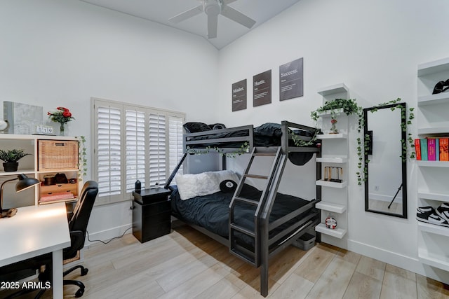 bedroom featuring baseboards, a ceiling fan, and light wood-style floors