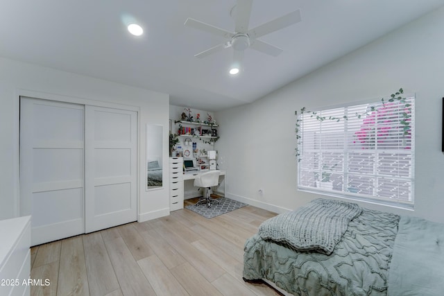 bedroom featuring lofted ceiling, recessed lighting, baseboards, a closet, and light wood-type flooring