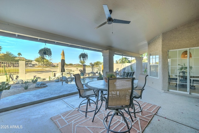 sunroom with vaulted ceiling and a ceiling fan