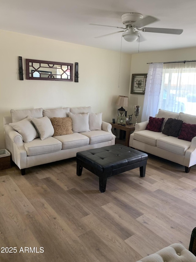 living room with hardwood / wood-style flooring and ceiling fan