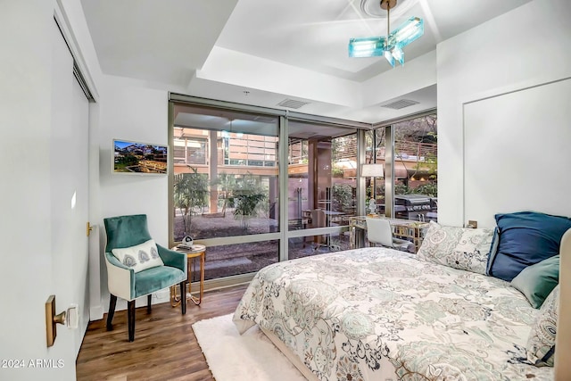 bedroom with ceiling fan and hardwood / wood-style flooring