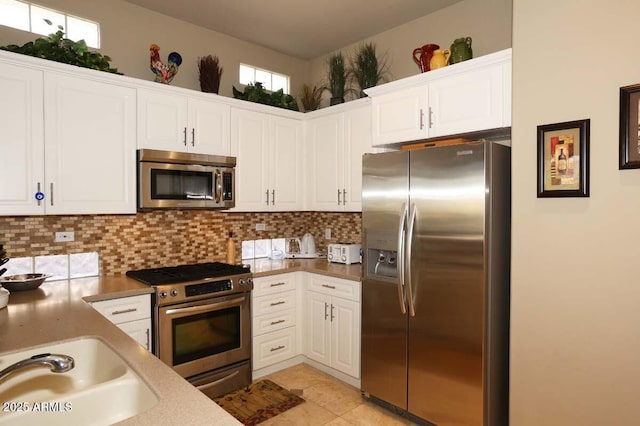 32764 N 68th Pl, Scottsdale, AZ 85266 - kitchen with a sink, tasteful backsplash, white cabinetry, appliances with stainless steel finishes, and light tile patterned floors