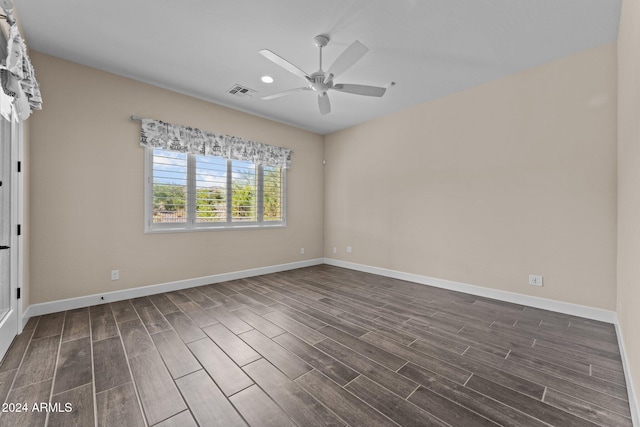 empty room with ceiling fan and dark wood-type flooring