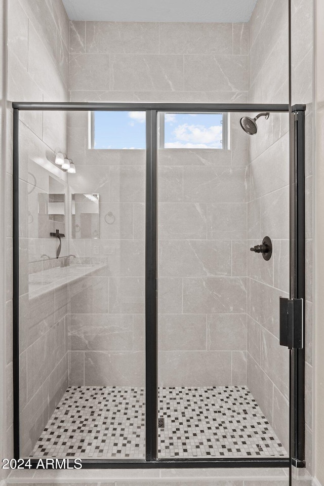 bathroom with a shower with shower door