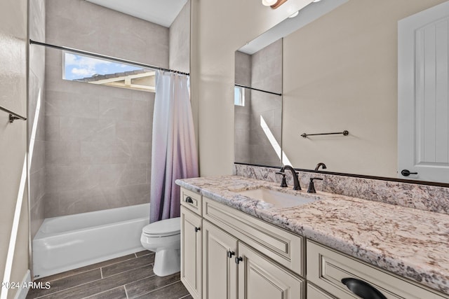 full bathroom featuring shower / bath combo with shower curtain, vanity, and toilet