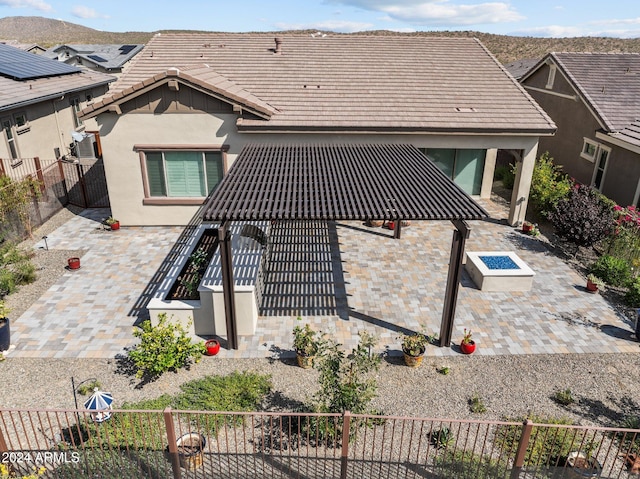 rear view of property with central air condition unit and a patio