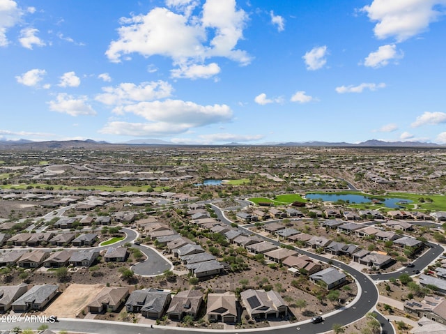 birds eye view of property with a water and mountain view