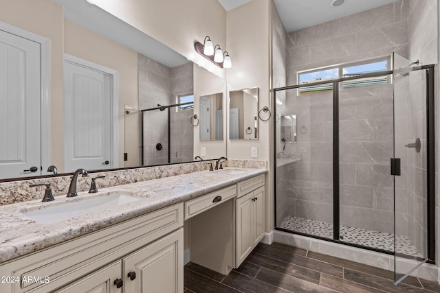 bathroom featuring walk in shower and vanity