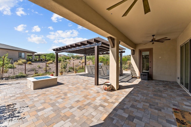 view of patio with ceiling fan, a pergola, and an outdoor fire pit