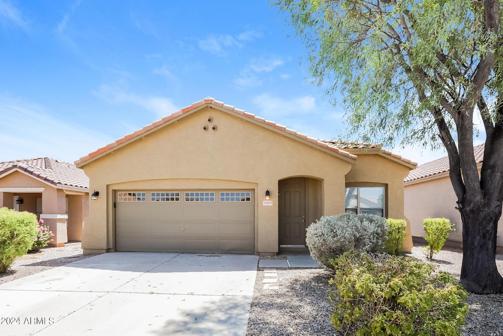 mediterranean / spanish-style home featuring a garage