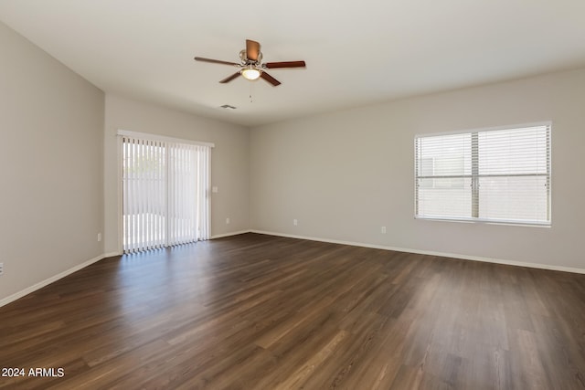 spare room with dark hardwood / wood-style flooring, plenty of natural light, and ceiling fan