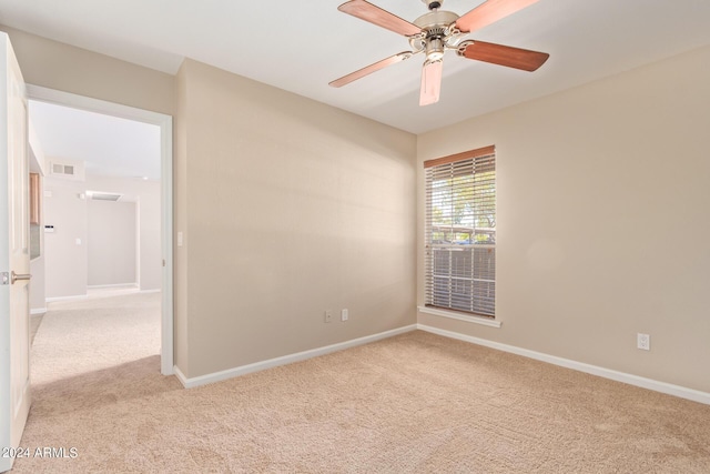 spare room featuring carpet floors and ceiling fan