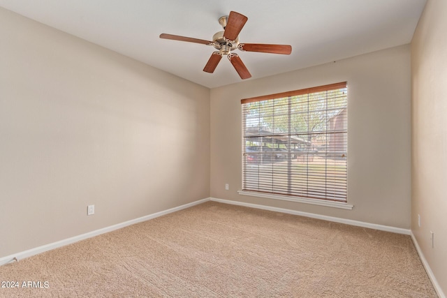 empty room featuring ceiling fan and carpet flooring