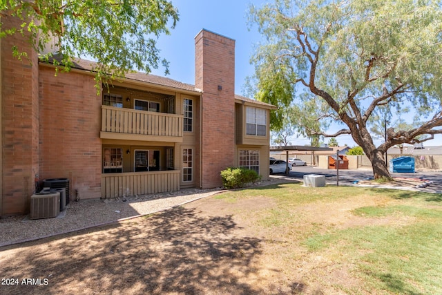 back of house featuring a balcony and central AC