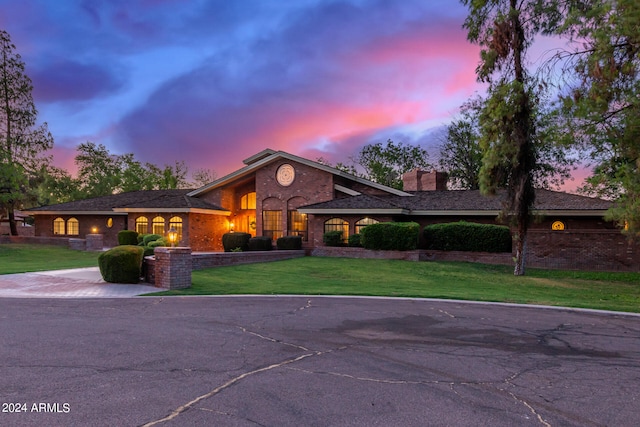 ranch-style home with a lawn