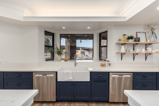 kitchen with blue cabinets, sink, hardwood / wood-style flooring, and stainless steel dishwasher