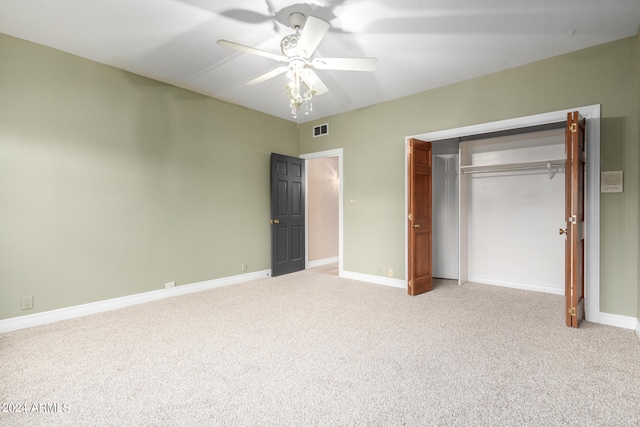 unfurnished bedroom featuring carpet, ceiling fan, and a closet