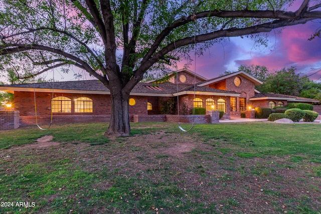 single story home with central AC and a lawn