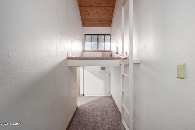 corridor featuring carpet floors, lofted ceiling, and wooden ceiling