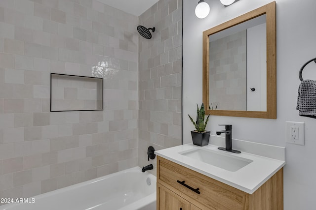 bathroom featuring vanity and tiled shower / bath