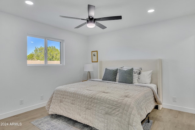 bedroom with ceiling fan and light hardwood / wood-style flooring