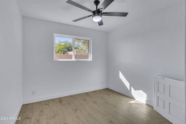 spare room featuring ceiling fan and light hardwood / wood-style flooring