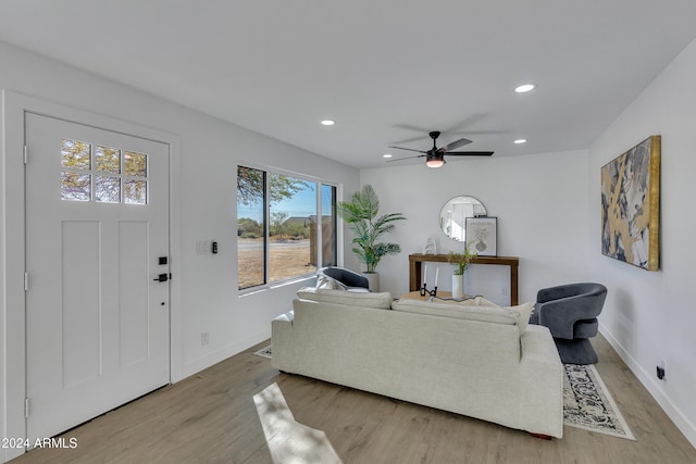 living room with light hardwood / wood-style floors and ceiling fan