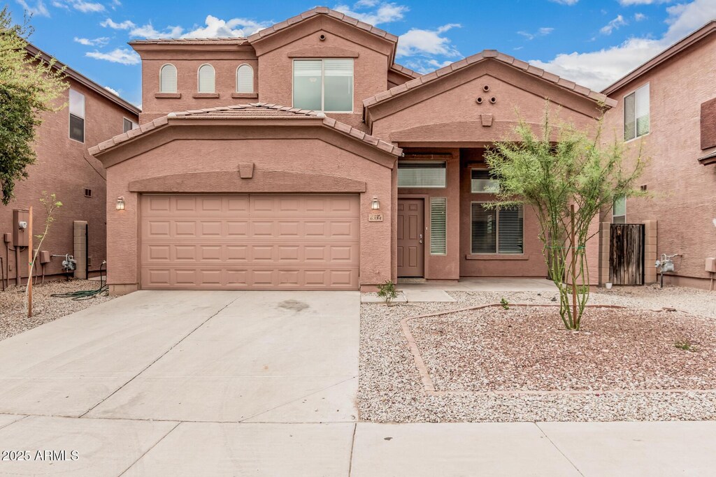 6334 S 37th Ln, Phoenix, AZ 85041 - view of front of property featuring a tile roof, stucco siding, a garage, and concrete driveway