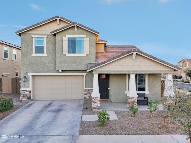 craftsman inspired home featuring a garage and covered porch