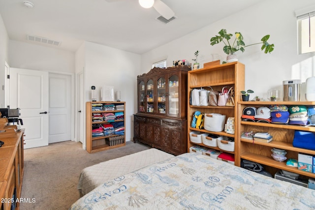 bedroom with light carpet, multiple windows, and ceiling fan