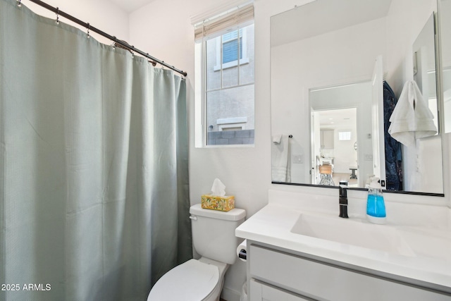 bathroom featuring vanity and toilet