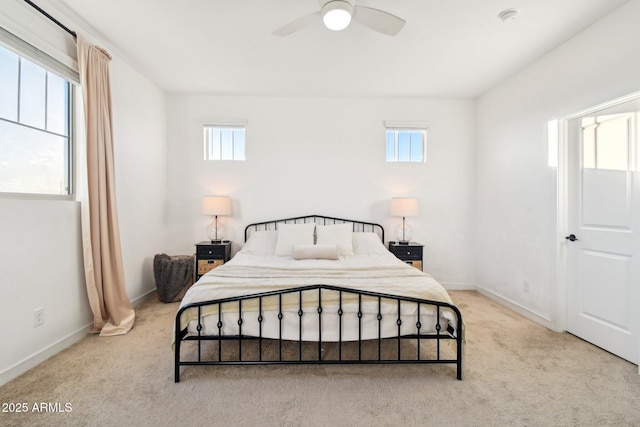 bedroom with ceiling fan and light carpet