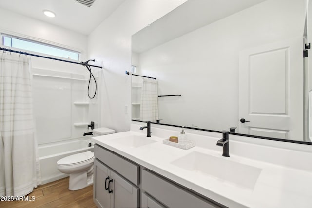 full bathroom featuring shower / tub combo with curtain, wood-type flooring, toilet, and vanity