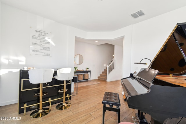 interior space with light hardwood / wood-style flooring and indoor bar