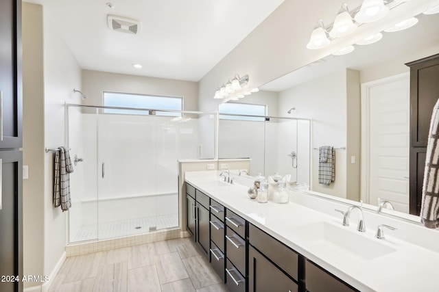 bathroom with vanity and a shower with shower door