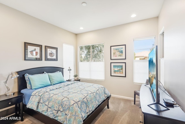 bedroom featuring light carpet